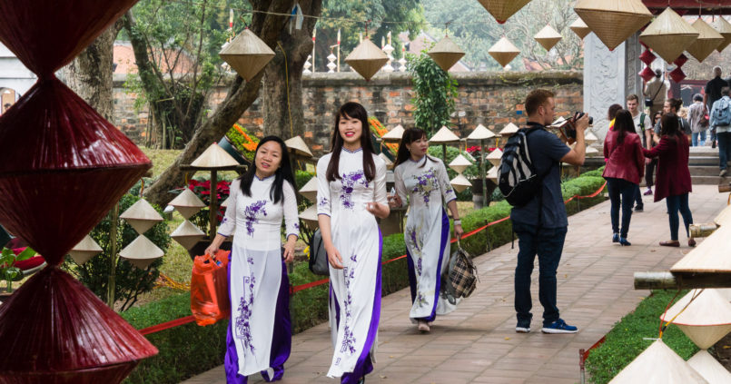 Vietnamese women in national clothes at the Temple of Literature in Hanoi
